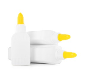 Photo of Bottles of glue with caps isolated on white