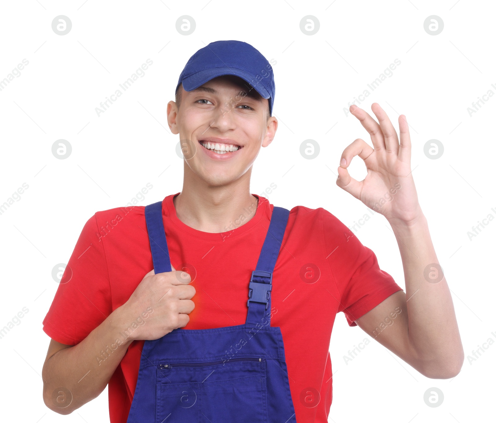 Photo of Happy young man in uniform showing OK gesture on white background