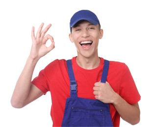 Photo of Happy young man in uniform showing OK gesture on white background