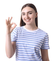 Happy young woman showing OK gesture on white background