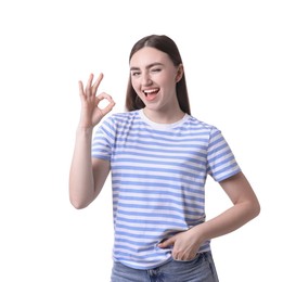 Photo of Happy young woman showing OK gesture on white background