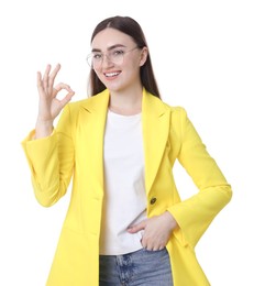 Happy young woman showing OK gesture on white background