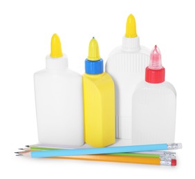 Photo of Bottles of glue and pencils isolated on white