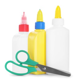 Photo of Bottles of glue and scissors isolated on white