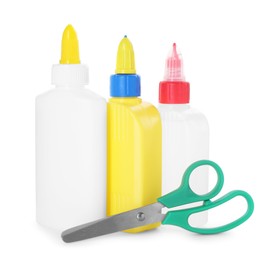 Photo of Bottles of glue and scissors isolated on white