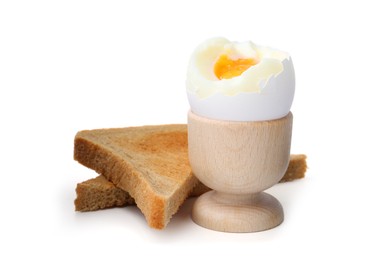 Photo of Soft boiled egg in eggcup with bread isolated on white