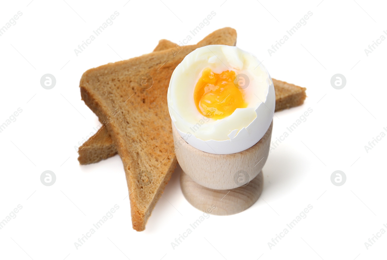 Photo of Soft boiled egg in eggcup with bread isolated on white