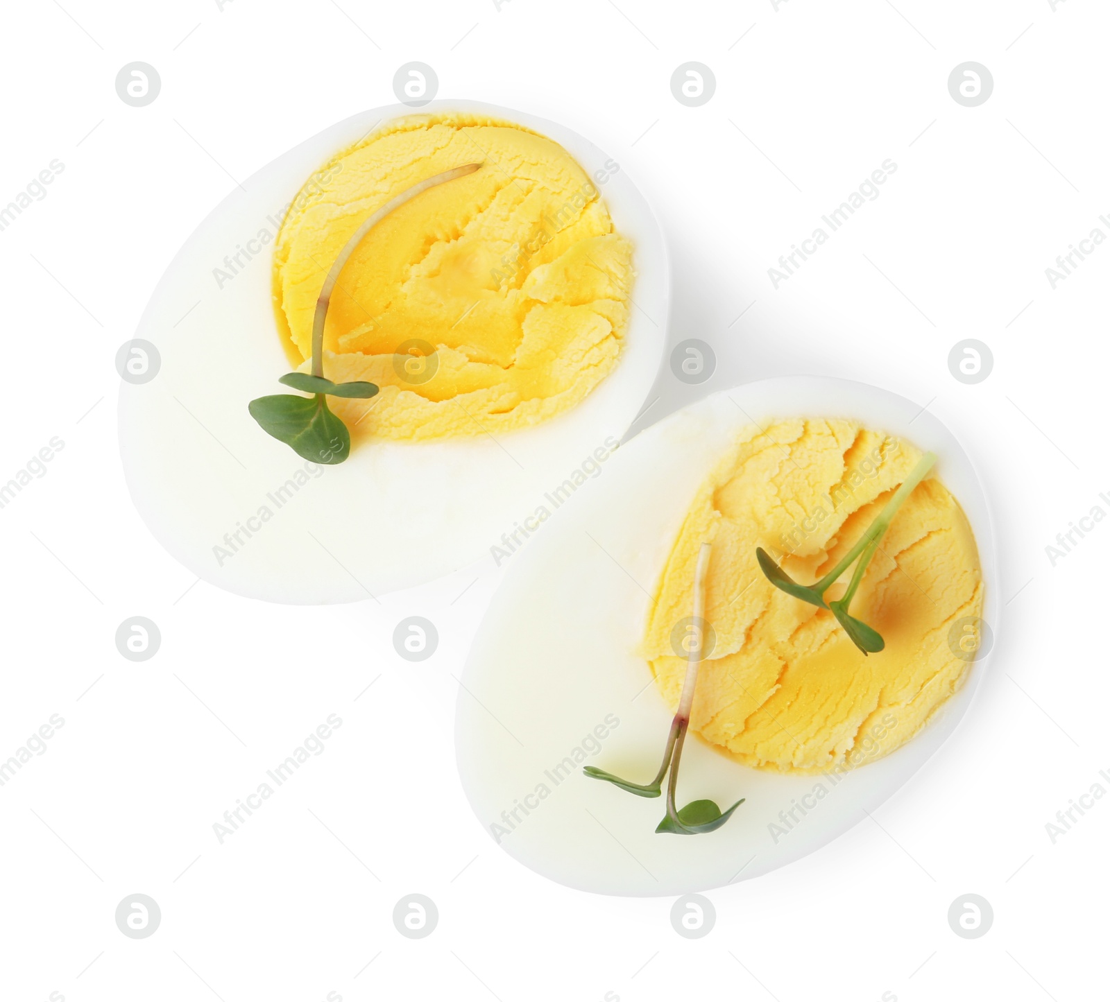 Photo of Halves of hard boiled egg isolated on white, top view