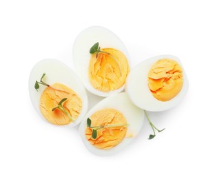 Photo of Halves of hard boiled eggs isolated on white, top view