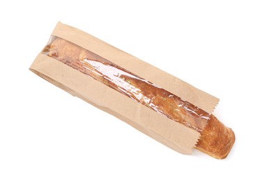 Photo of Fresh baguette in paper bag isolated on white, top view