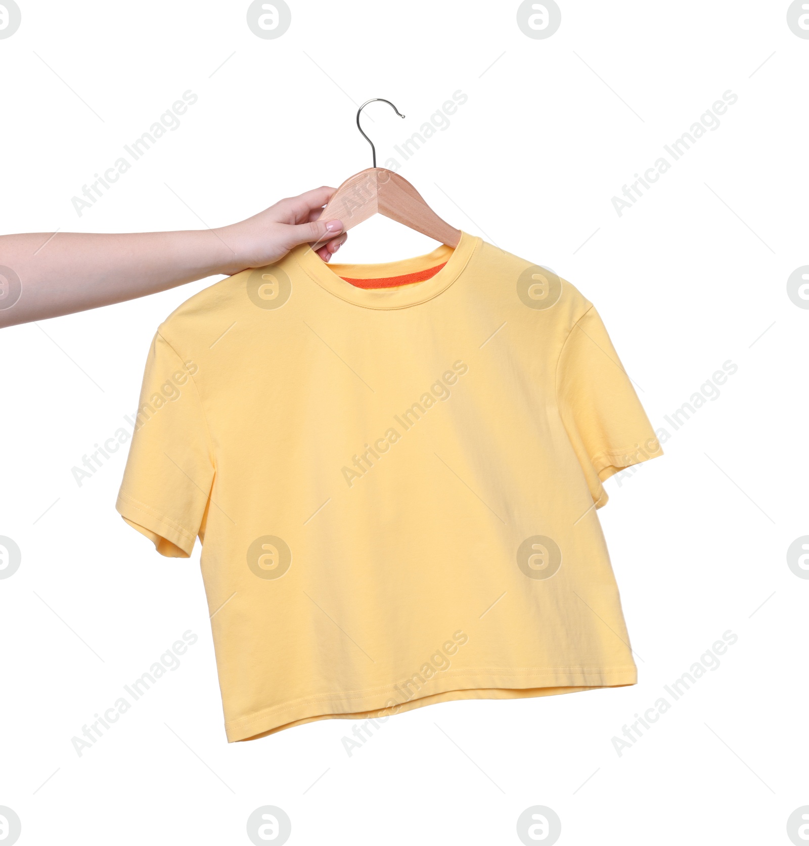 Photo of Woman holding hanger with yellow t-shirt on white background, closeup