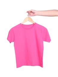 Photo of Woman holding hanger with pink t-shirt on white background, closeup