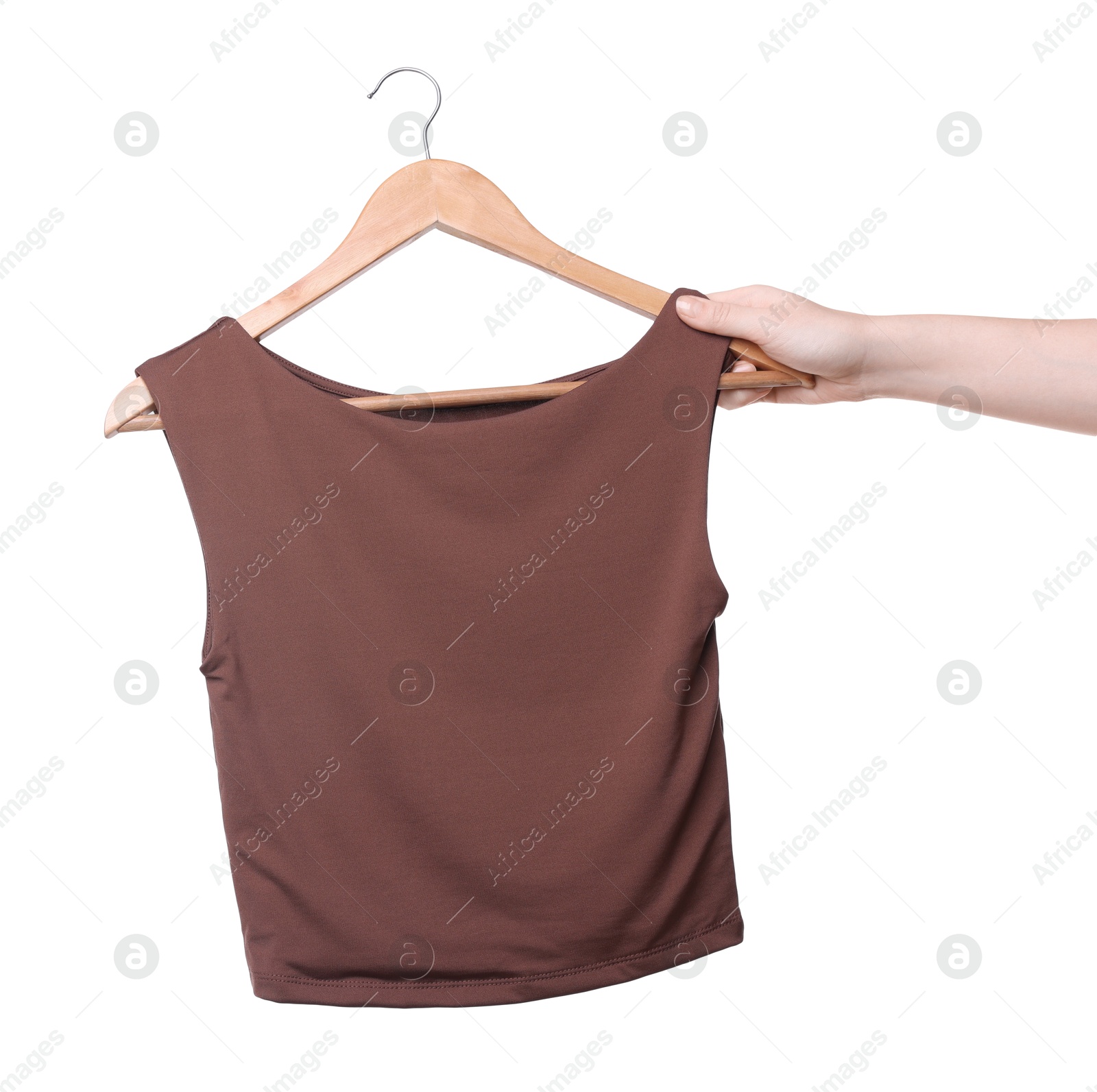 Photo of Woman holding hanger with brown tank top on white background, closeup