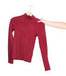 Photo of Woman holding hanger with red sweater on white background, closeup