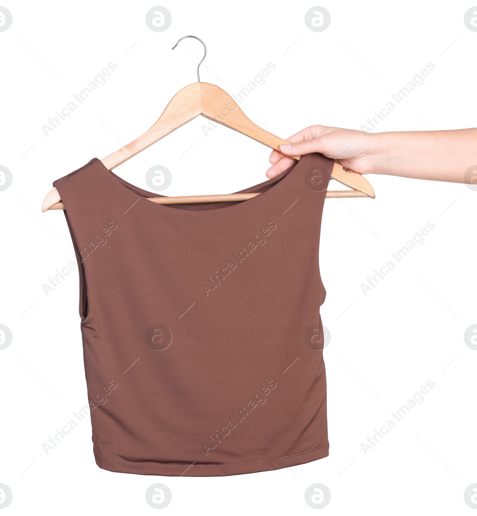 Photo of Woman holding hanger with brown top on white background, closeup