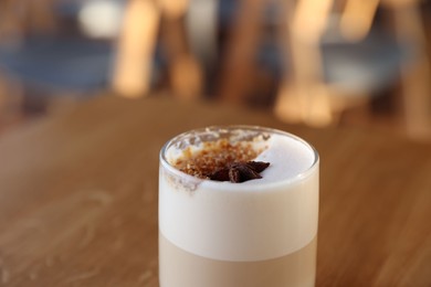 Photo of Glass of aromatic coffee on table in cafe, closeup. Space for text