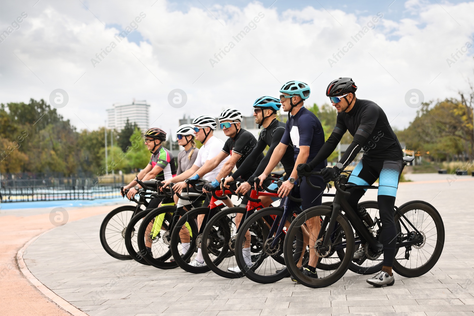 Photo of Group of athletic people with bicycles outdoors