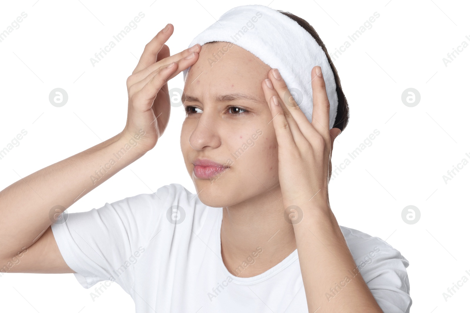 Photo of Upset teenage girl popping pimple on her face against white background. Acne problem