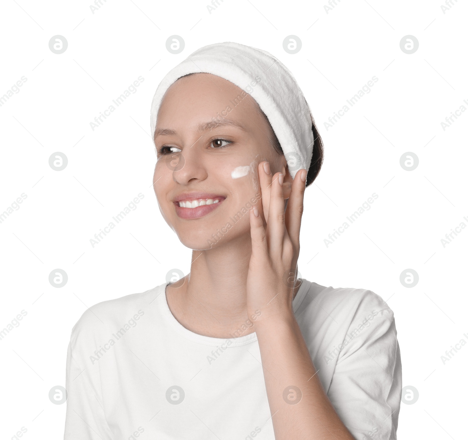 Photo of Teenage girl with acne problem applying cream on white background