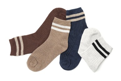 Photo of Different soft socks isolated on white, top view