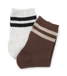 Photo of Pairs of folded soft socks isolated on white, top view