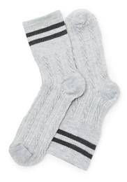 Photo of Pair of soft socks isolated on white, top view