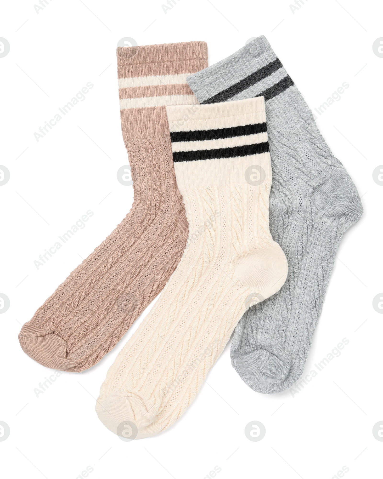 Photo of Different soft socks isolated on white, top view