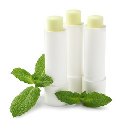 Photo of Mint lip balms and green leaves isolated on white. Cosmetic product