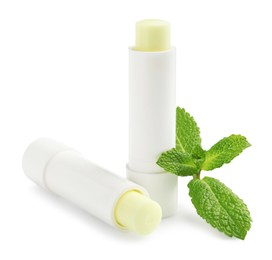 Photo of Mint lip balms and green leaves isolated on white. Cosmetic product