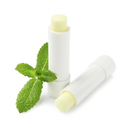 Photo of Mint lip balms and green leaves isolated on white. Cosmetic product