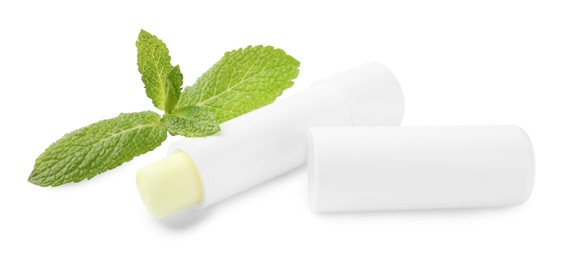 Photo of Mint lip balm and green leaves isolated on white. Cosmetic product