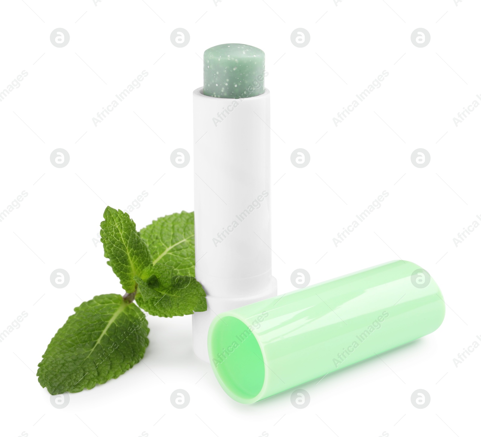 Photo of Mint lip balm and green leaves isolated on white. Cosmetic product