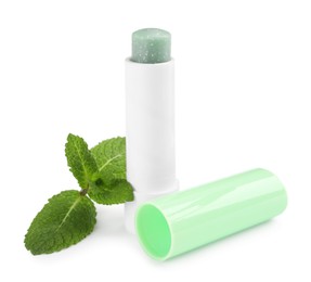 Mint lip balm and green leaves isolated on white. Cosmetic product