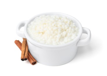 Photo of Delicious rice pudding with cinnamon sticks isolated on white