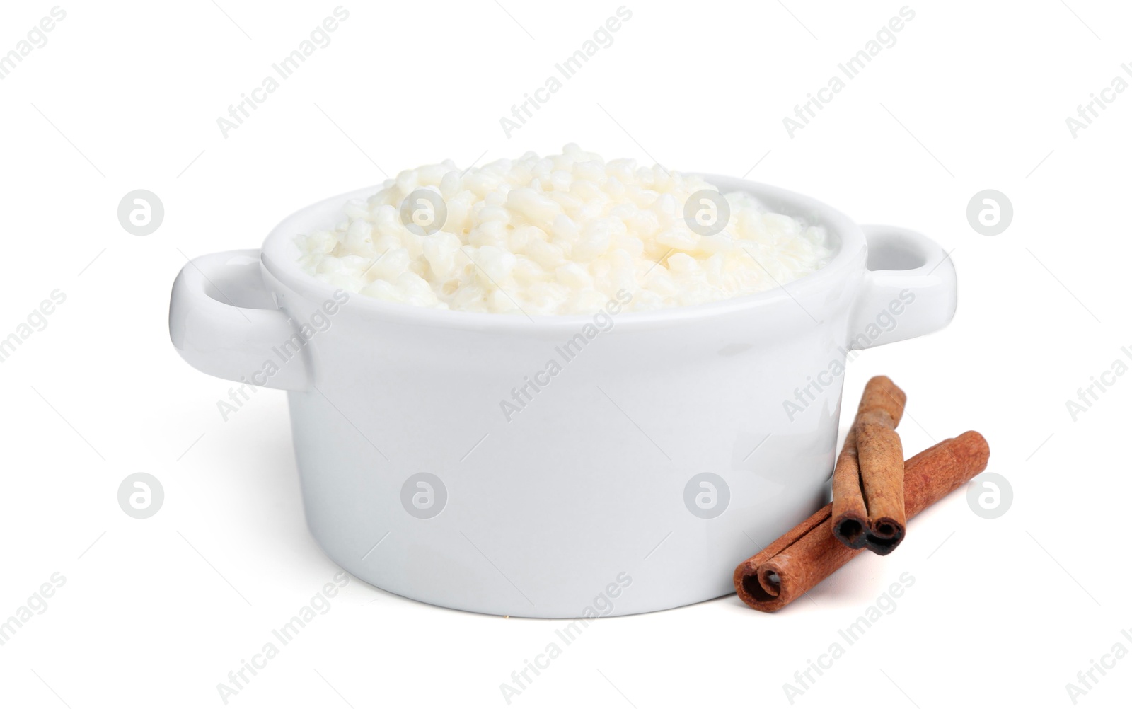 Photo of Delicious rice pudding with cinnamon sticks isolated on white