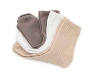 Photo of Pairs of soft socks isolated on white, top view