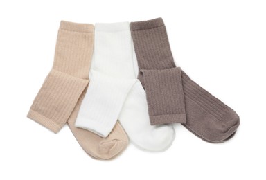 Photo of Pairs of soft socks isolated on white, top view