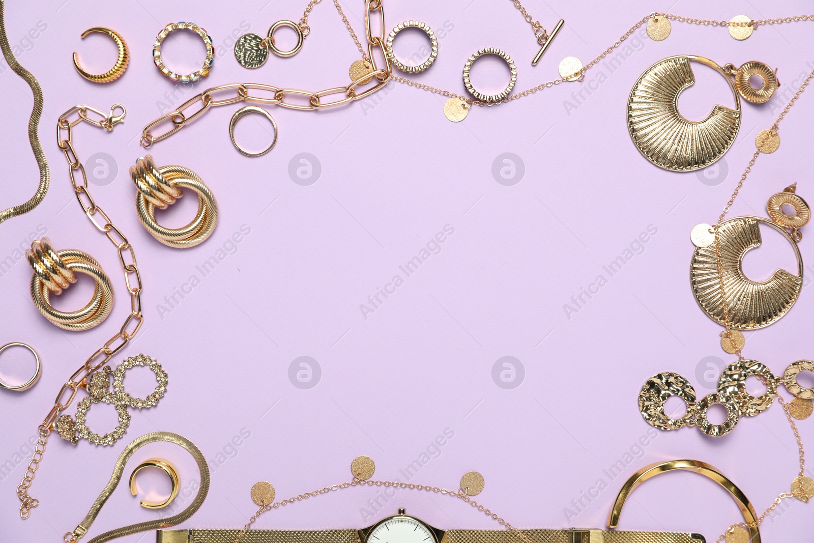 Photo of Frame made of golden jewelry on violet background, flat lay. Space for text