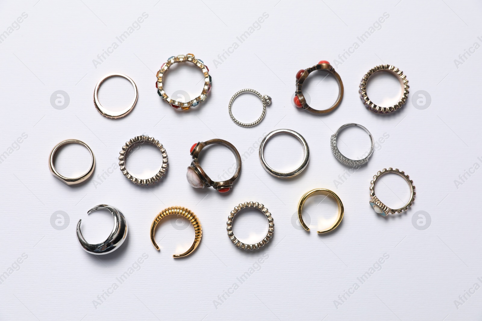 Photo of Many different rings on white background, flat lay