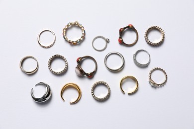 Photo of Many different rings on white background, flat lay