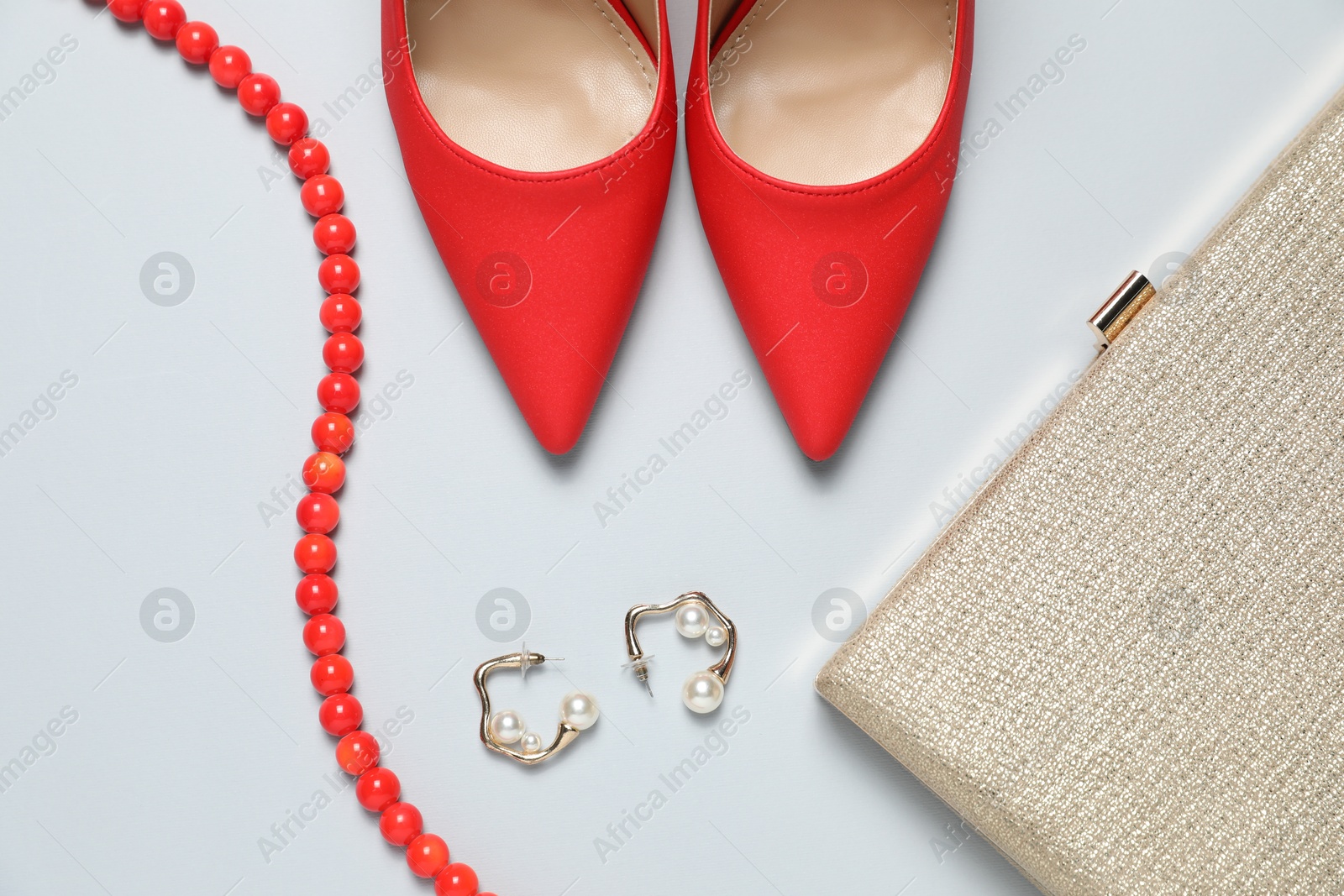 Photo of Stylish shoes, earrings, necklace and purse on light grey background, flat lay