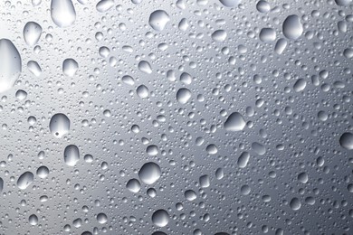 Photo of Water drops on glass surface, top view