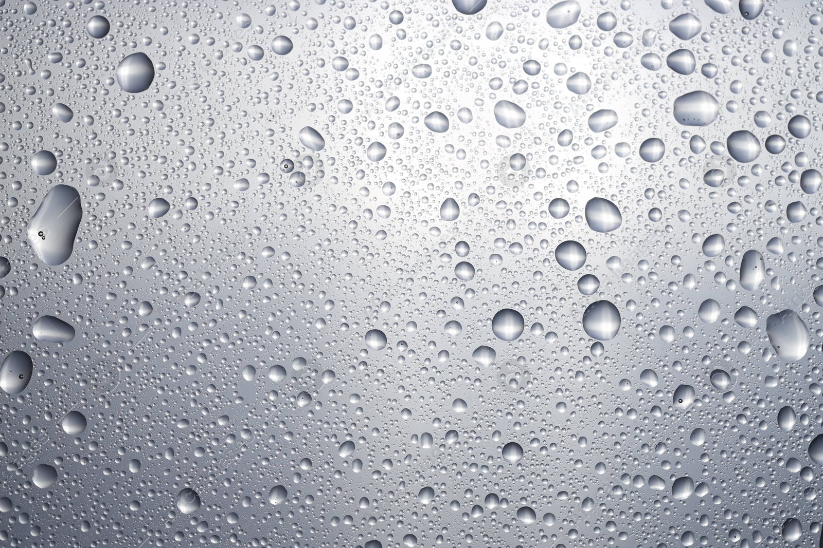 Photo of Water drops on glass surface, top view