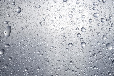 Water drops on glass surface, top view