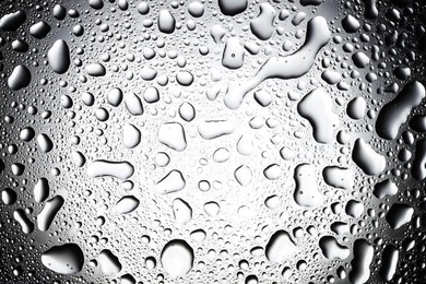 Photo of Water drops on glass surface, top view