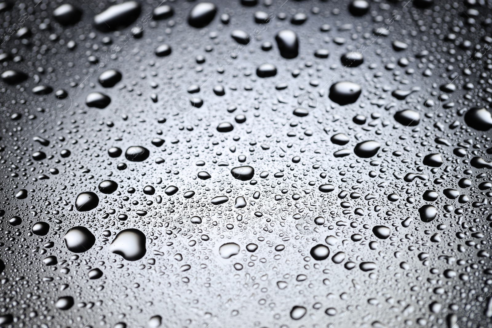 Photo of Water drops on glass surface, closeup view