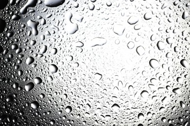 Photo of Water drops on glass surface, top view