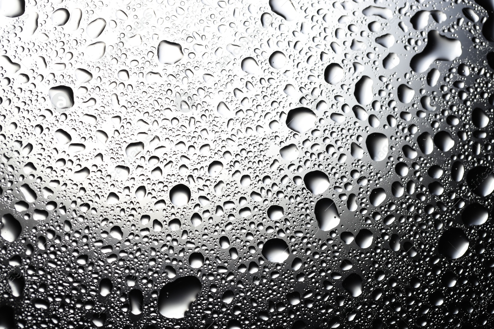 Photo of Water drops on glass surface, top view