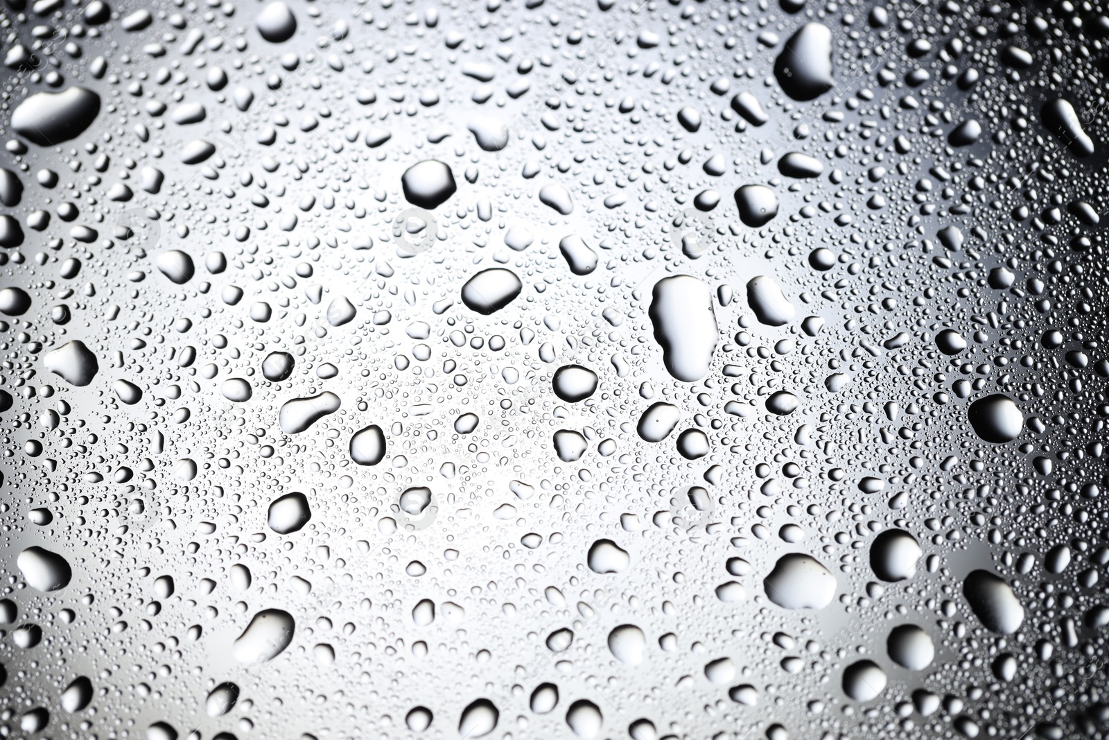 Photo of Water drops on glass surface, top view