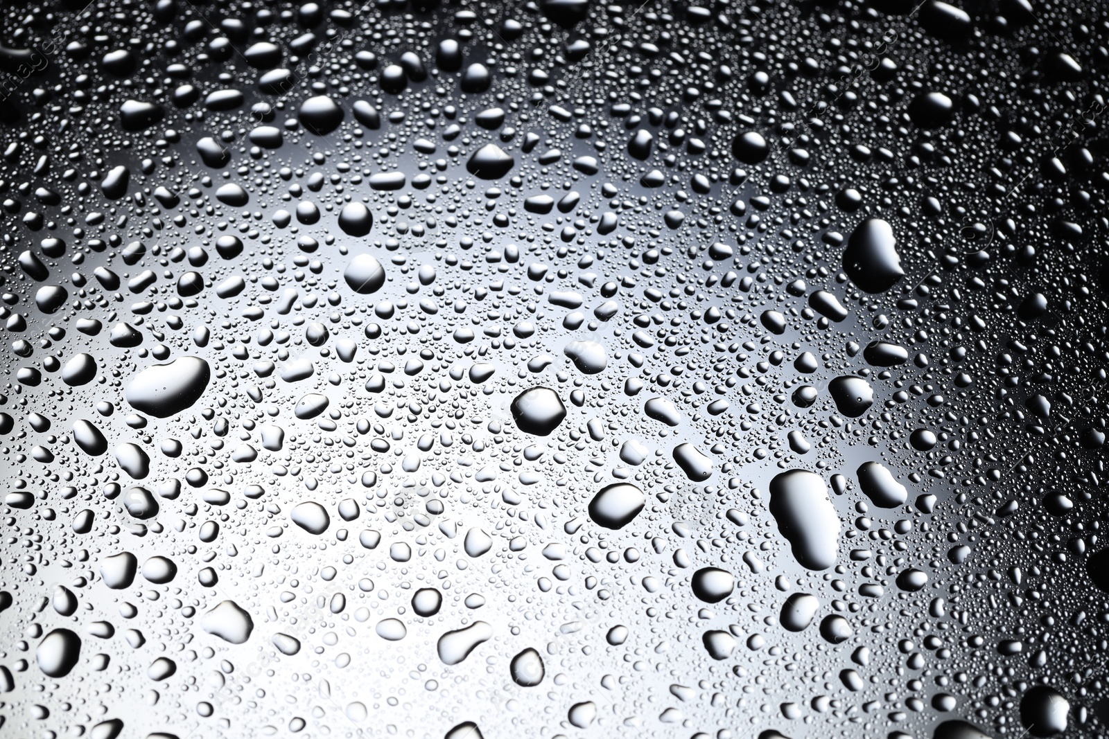 Photo of Water drops on glass surface, top view